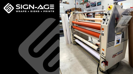 The old Sign-Age laminator on the right, with the Sign-Age logo and graphic element on a black background on left.