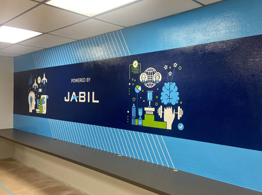 Wall mural reading 'Powered by JABIL' in a contemporary design of blues and greens