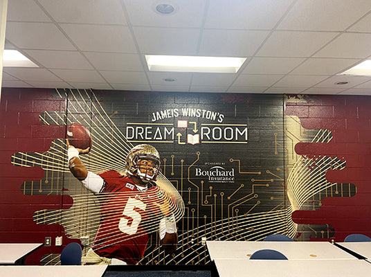 Wall mural of a football player in a room with 'Jameis Winston's Dream Room' sign.
