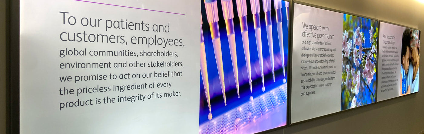 Wall with large posters displaying a message to patients, employees, and stakeholders about product integrity.