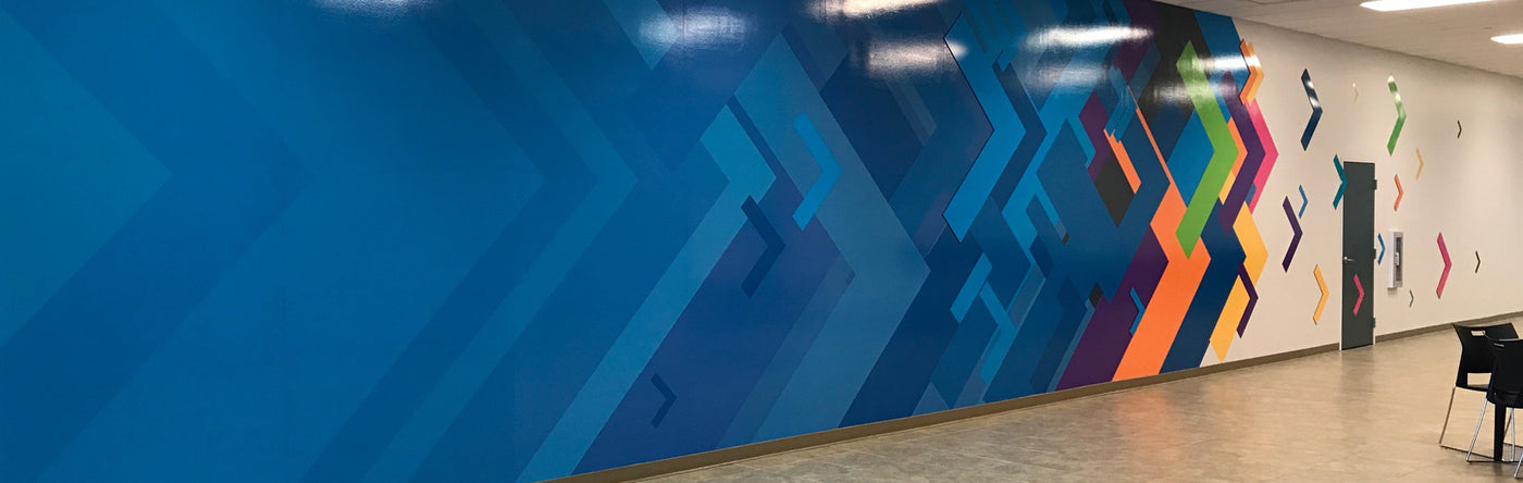 Colorful geometric wall design on a large wall mural in an indoor setting
