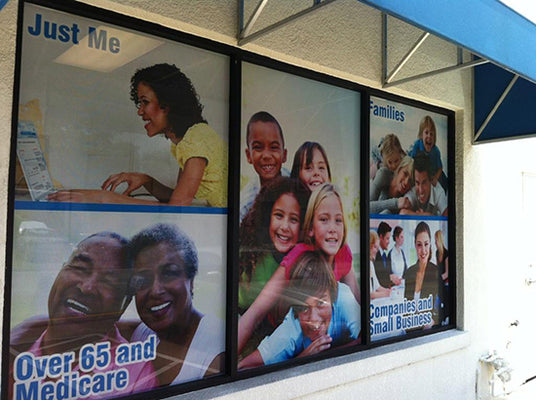 Multiple window graphics in a storefront with various images and text.