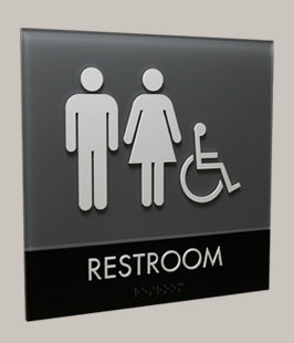 ADA restroom sign with gender symbols and wheelchair icons with tactile letters and Braille, reading 'Restroom'