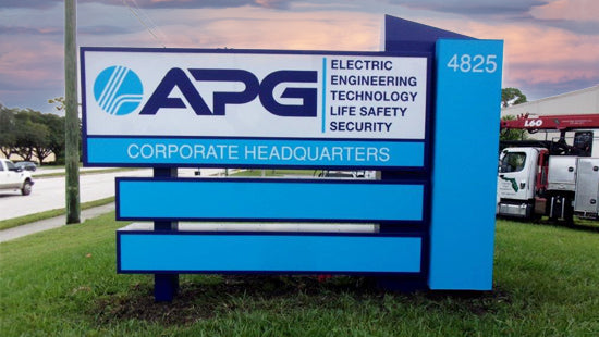 APG illuminated monument sign at the corporate headquarters with a blue and white design.
