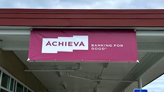 Achieva banner on a building exterior with 'Banking for Good' text.