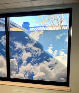 Window privacy film with a design of clouds on a blue sky