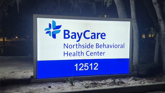 BayCare Northside Behavioral Health Center Flex Face sign at night with blue and white colors.