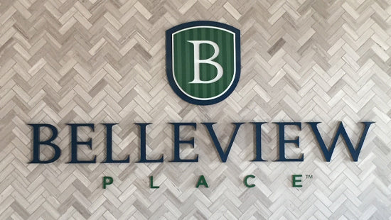 Bellevue Place dimensional letters and logo sign on a herringbone patterned background