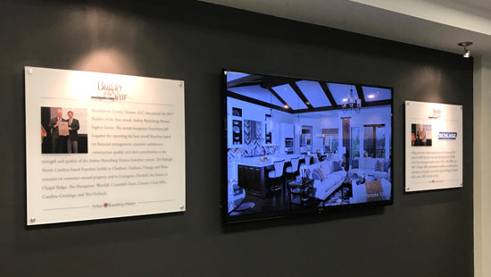 Wall display of posters showing a room interior and two informational panels.