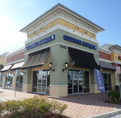 Commercial building with blue 'Coldwell Banker' illuminated channel letter sign and symbol