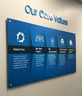 Blue poster sign with 'Our Care Values' on a wall