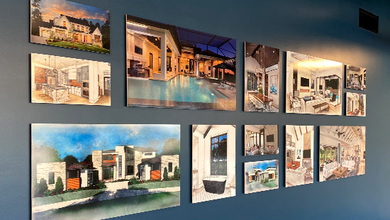 Set of posters on a wall, showing interior and exterior views of homes.