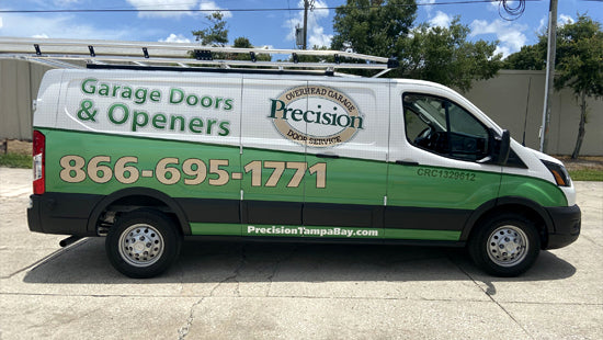 Van with Precision Garage Doors & Openers branding and contact information on a full vehicle wrap.