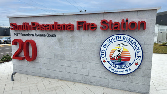 South Pasadena Fire Station dimensional sign with red letters and a city seal on a light gray monument sign.