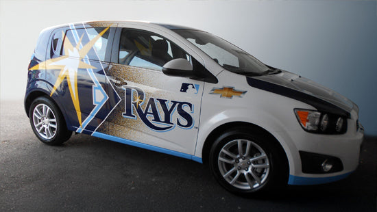 Car with vehicle wrap of Tampa Bay Rays and Chevrolet logos on a gray, black and yellow background