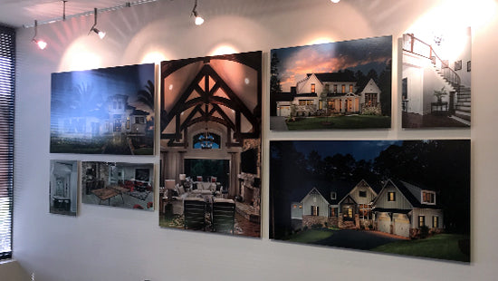 Set of framed photographic posters of houses on a gallery wall