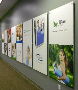 Wall with multiple promotional posters featuring various brands and images.